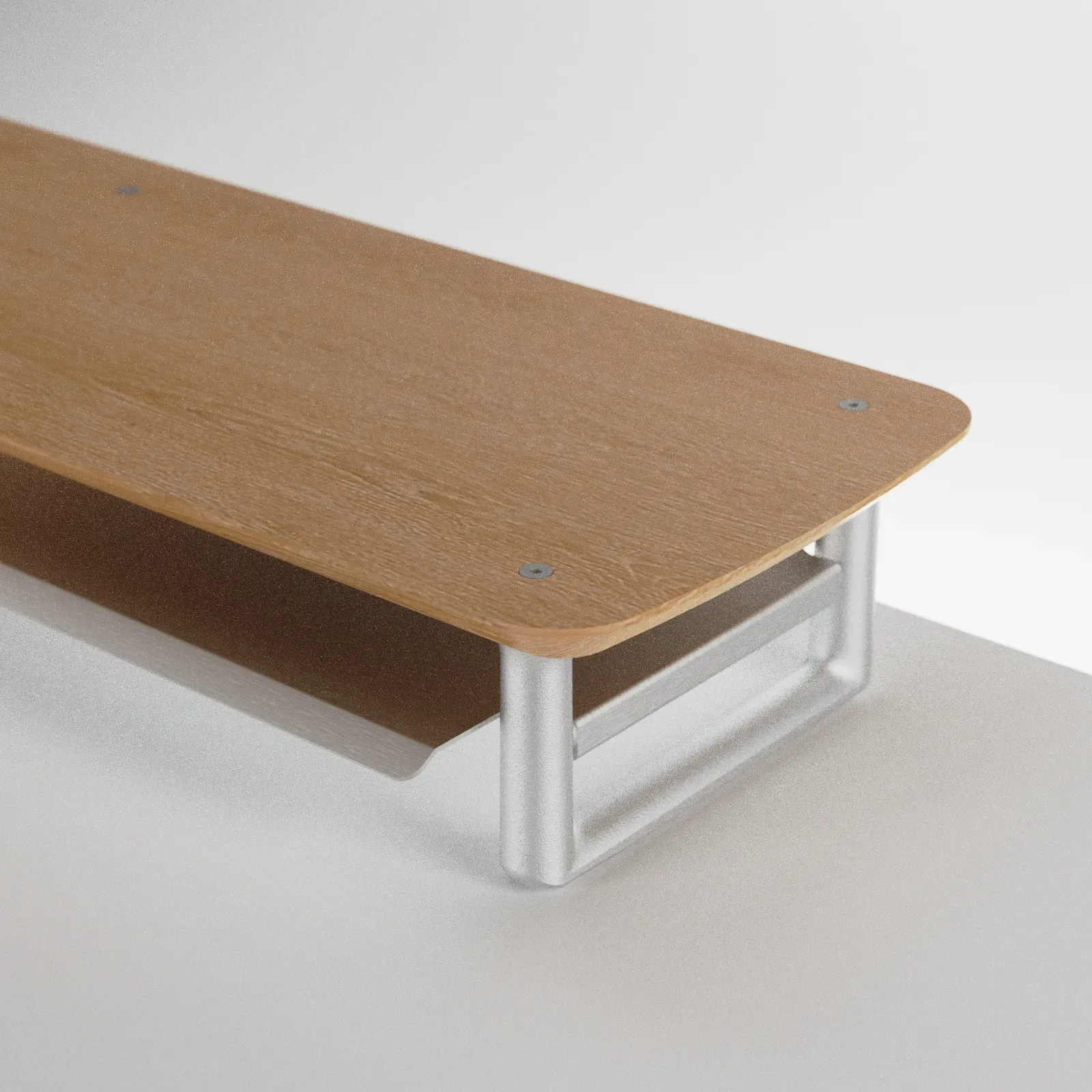 Elevador de monitor en madera y tubo. La forma sale de un pórtico japonés; la validación, de prototipos impresos.
